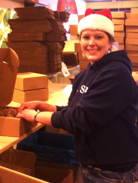 Brandy, surrounded by our packaging supplies, is making holiday gift boxes as fast as the orders pour in.