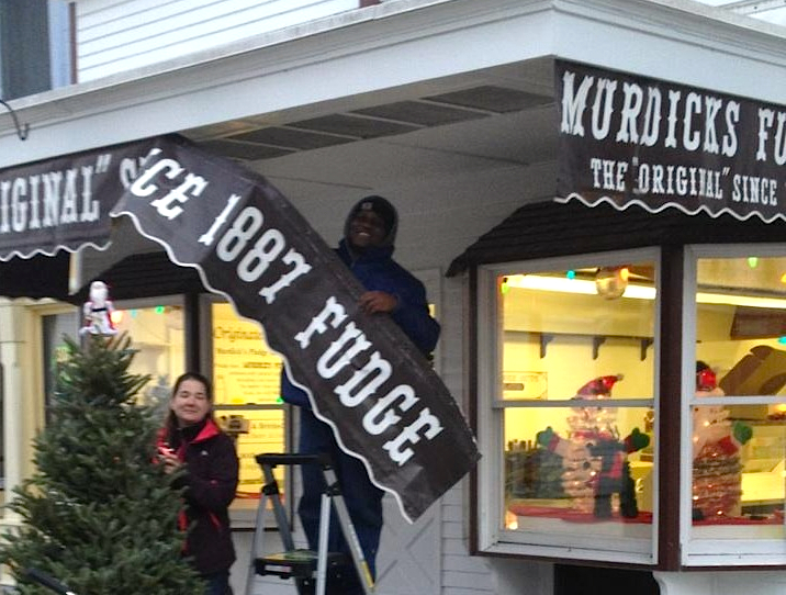 Nikki and Carnel hang our summer colors to celebrate the re-opening of our Mackinac Island store.