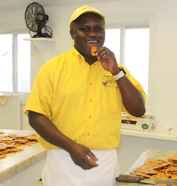 Carnel, Original Murdick's Fudge expert fudge maker, samples his latest batch of peanut brittle.